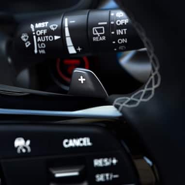 2026 Honda Civic Hatchback Sport Touring Hybrid close up of the steering wheel paddle shifters (Compact Hatchback).